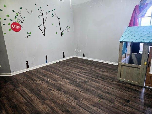 empty room with dark wood-type flooring