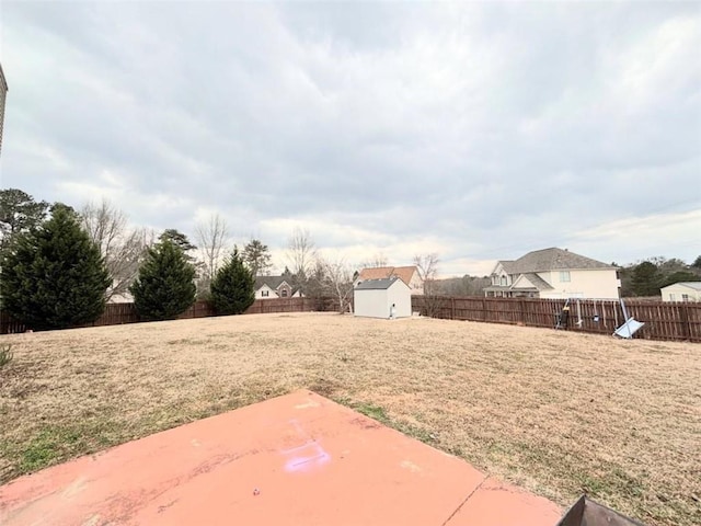 view of yard with a storage unit and a patio