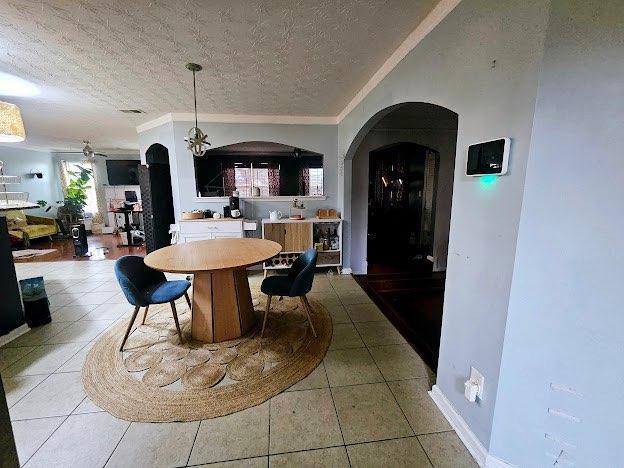 tiled dining area featuring crown molding and a textured ceiling