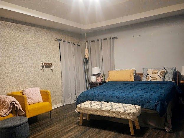 bedroom featuring dark wood-type flooring