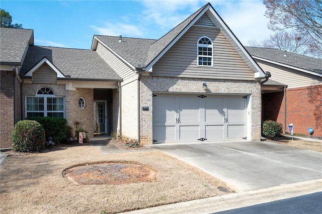 view of front of property with brick siding, driveway, and a shingled roof