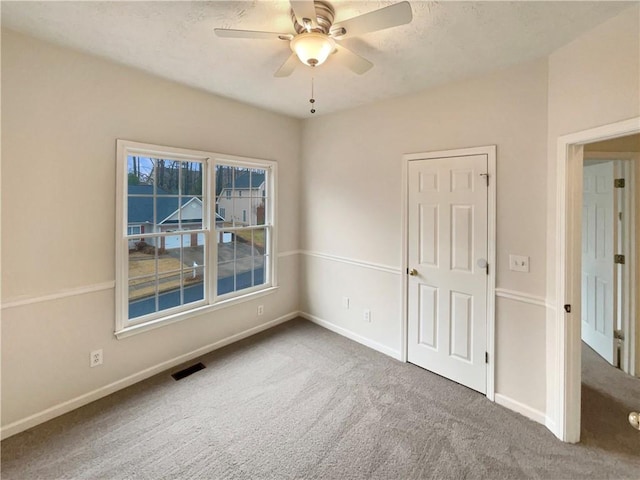 unfurnished bedroom with visible vents, baseboards, and carpet