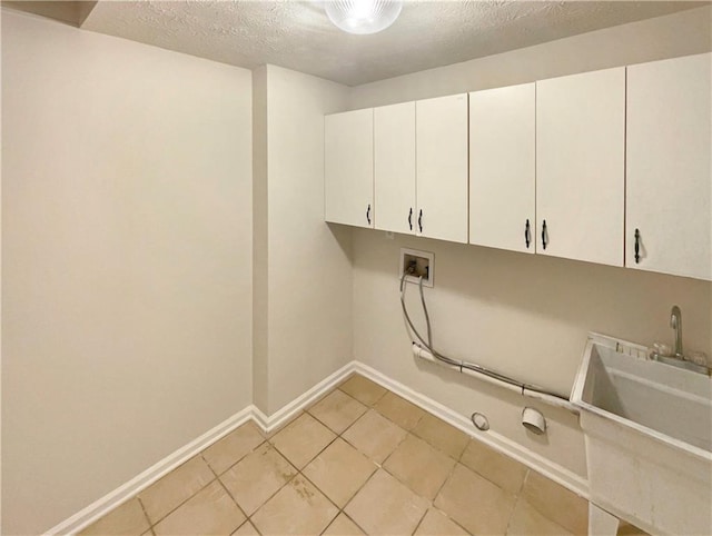 laundry room featuring washer hookup, a sink, cabinet space, baseboards, and gas dryer hookup