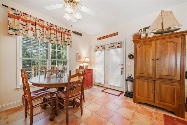 tiled dining room with ceiling fan and a healthy amount of sunlight