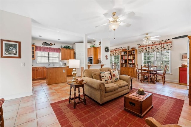 tiled living room with ceiling fan