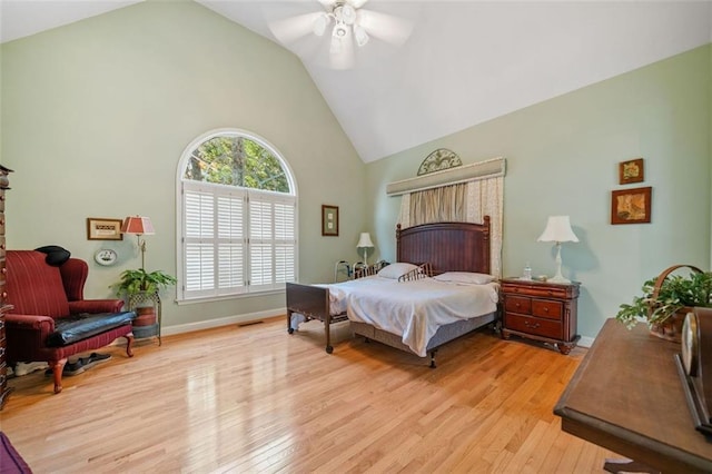 bedroom with ceiling fan, light hardwood / wood-style flooring, and vaulted ceiling