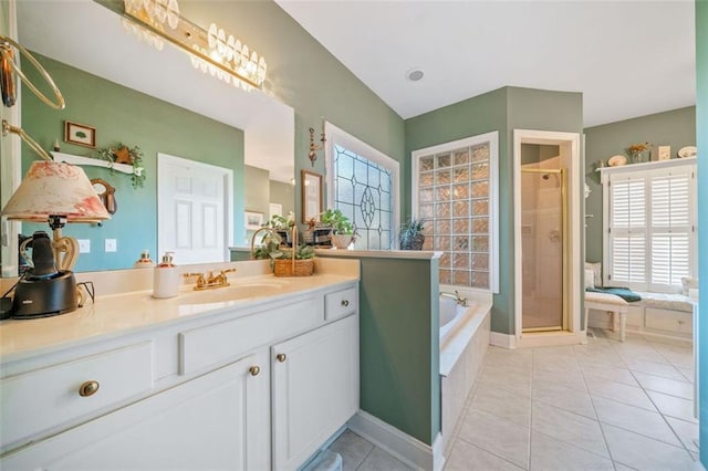 bathroom featuring tile patterned floors, vanity, and separate shower and tub