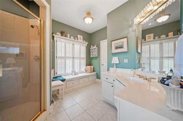 bathroom with walk in shower, vanity, and tile patterned floors