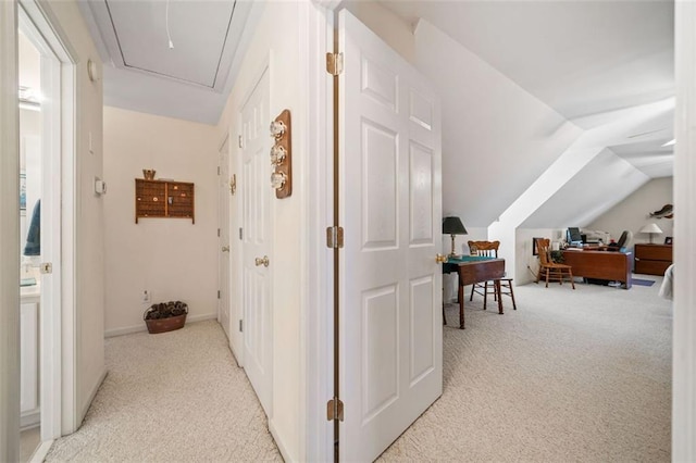 corridor with light carpet and lofted ceiling