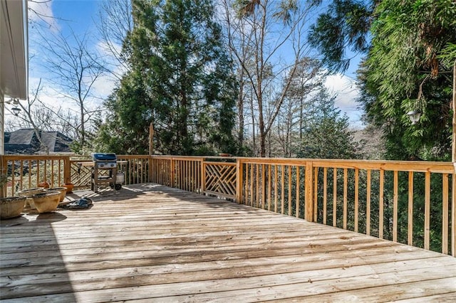 wooden terrace with a grill