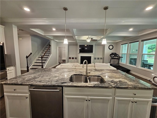 kitchen featuring ceiling fan, hanging light fixtures, sink, and white cabinetry