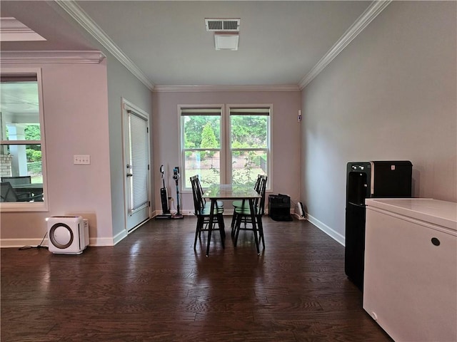 dining area with dark hardwood / wood-style floors and crown molding