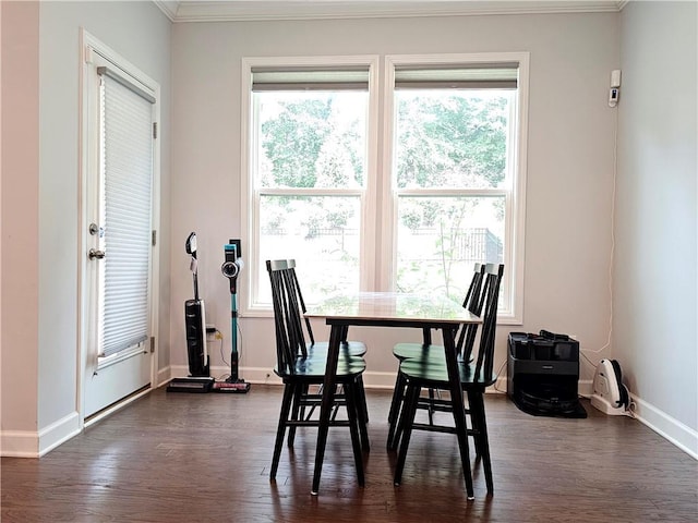 dining room with dark hardwood / wood-style floors, crown molding, and a wealth of natural light