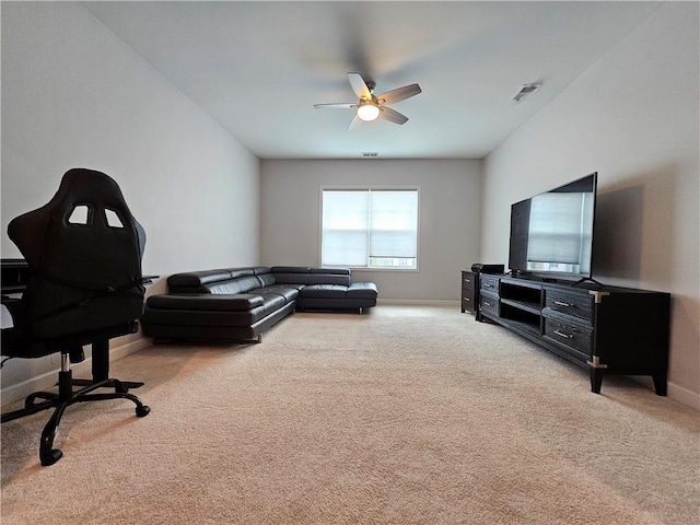 living room with ceiling fan and light colored carpet