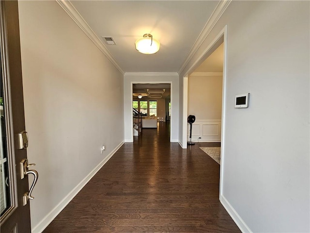 hallway with ornamental molding and dark wood-type flooring