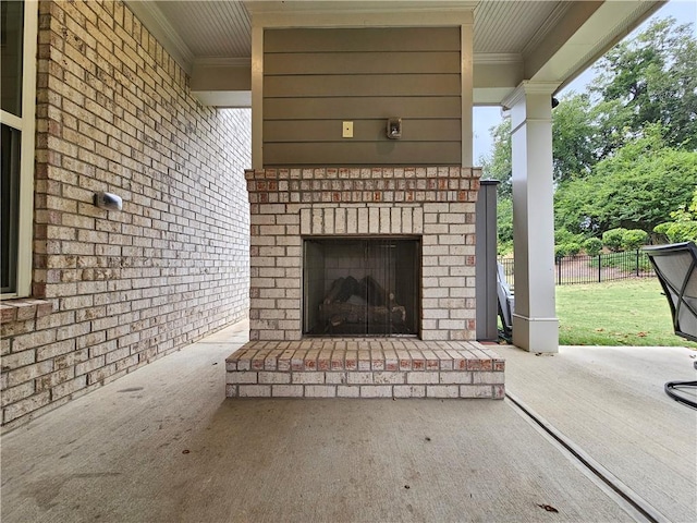 view of patio featuring an outdoor brick fireplace