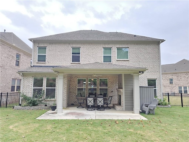 rear view of property with a lawn and a patio area