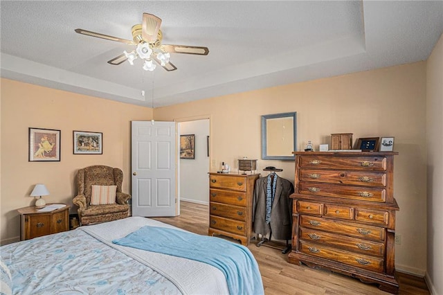 3264 Salem Cove Trl SE, Conyers, GA 30013 - bedroom with a tray ceiling, wood finished floors, and a ceiling fan