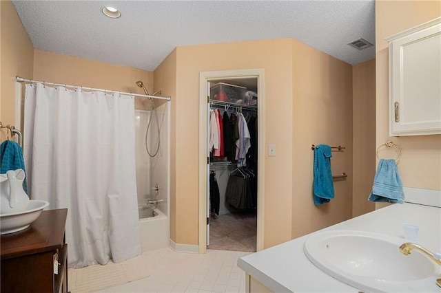 3264 Salem Cove Trl SE, Conyers, GA 30013 - bathroom with vanity, shower / bath combo, a textured ceiling, tile patterned flooring, and a walk in closet