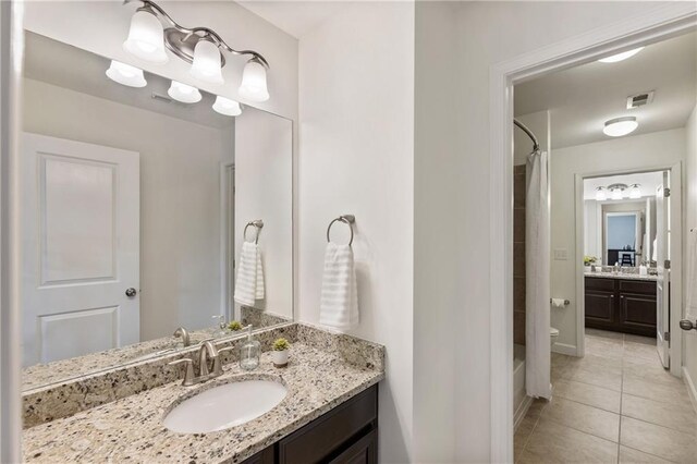 12380 Peyton Farm Way, Alpharetta, GA 30004 - full bathroom featuring tile patterned flooring, vanity, shower / bath combo, baseboards, and toilet