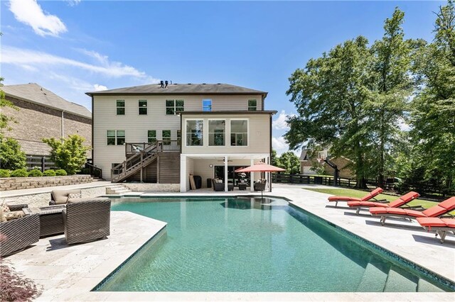 12380 Peyton Farm Way, Alpharetta, GA 30004 - rear view of property with stairs, a patio area, an outdoor pool, fence, and a wooden deck