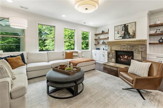 12380 Peyton Farm Way, Alpharetta, GA 30004 - living room featuring crown molding, a fireplace, wood finished floors, built in shelves, and recessed lighting