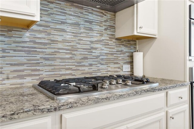 5910 Roxboro Ct, Cumming, GA 30040 - kitchen with tasteful backsplash, white cabinetry, extractor fan, and stainless steel gas stovetop