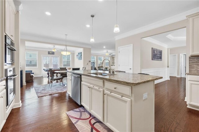 5910 Roxboro Ct, Cumming, GA 30040 - kitchen with a wealth of natural light, dark wood-type flooring, an island with sink, a sink, and stainless steel dishwasher