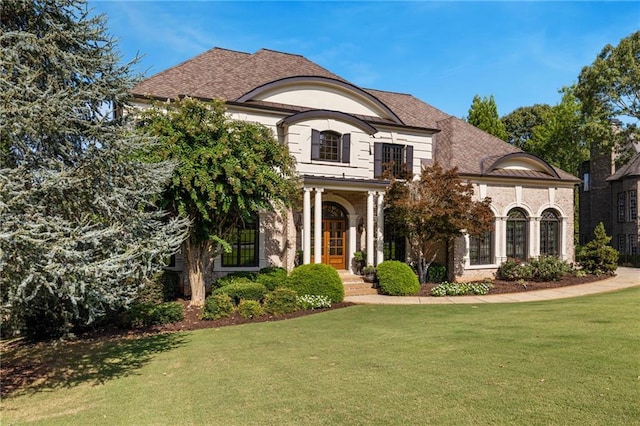 french country home featuring a front lawn