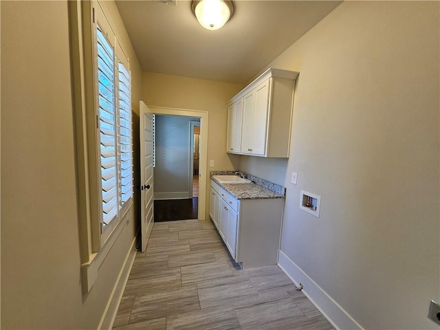 laundry room with electric dryer hookup, sink, hookup for a washing machine, and cabinets