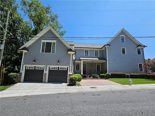 view of front of property featuring a garage and a porch