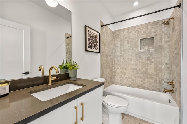 full bathroom featuring vanity, toilet, and tiled shower / bath combo