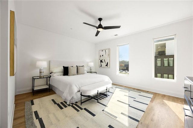 bedroom with ceiling fan and light wood-type flooring