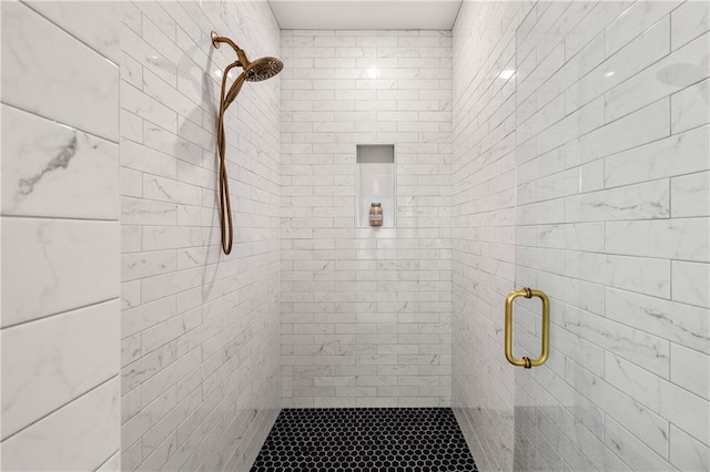 bathroom with a shower with door