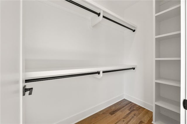 walk in closet featuring hardwood / wood-style flooring