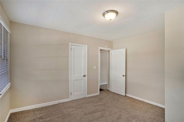 unfurnished bedroom with a closet and carpet