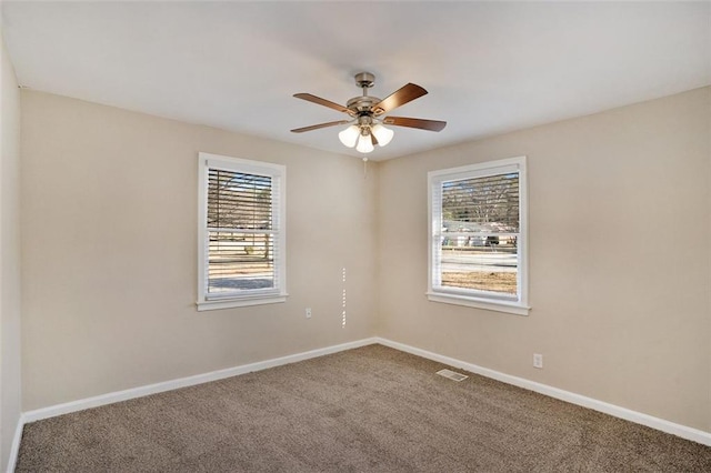 unfurnished room featuring a healthy amount of sunlight, ceiling fan, and carpet flooring