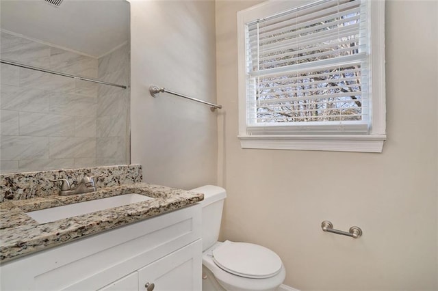 bathroom with toilet and vanity