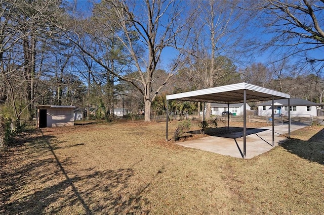 view of yard with a storage unit and a carport