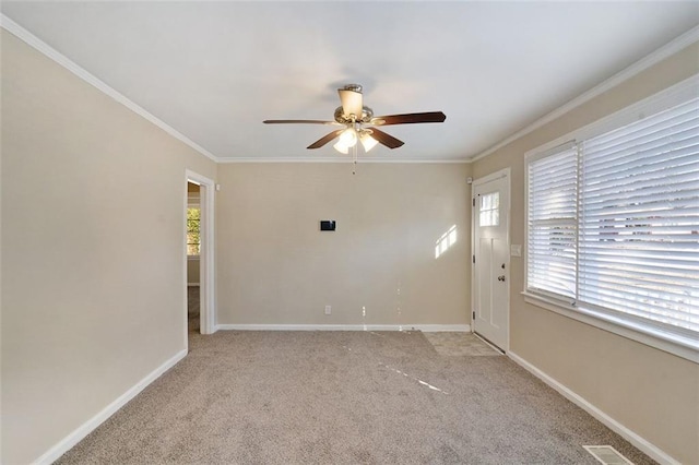 spare room featuring ornamental molding, ceiling fan, and light colored carpet