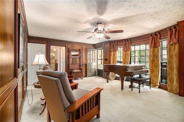 5396 Amhurst Dr, Peachtree Corners, GA 30092 - living area with light carpet, a textured ceiling, wooden walls, and ceiling fan
