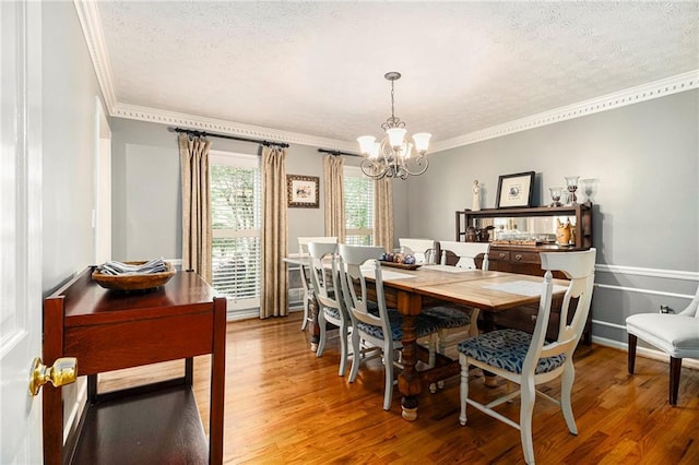 5396 Amhurst Dr, Peachtree Corners, GA 30092 - dining space featuring a chandelier, ornamental molding, a textured ceiling, and light wood finished floors