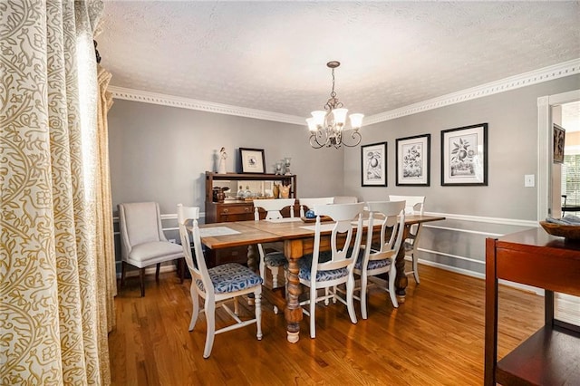 5396 Amhurst Dr, Peachtree Corners, GA 30092 - dining space featuring a chandelier, wood finished floors, ornamental molding, and a textured ceiling