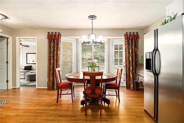 5396 Amhurst Dr, Peachtree Corners, GA 30092 - dining area featuring light wood-type flooring, a chandelier, a textured ceiling, and a ceiling fan