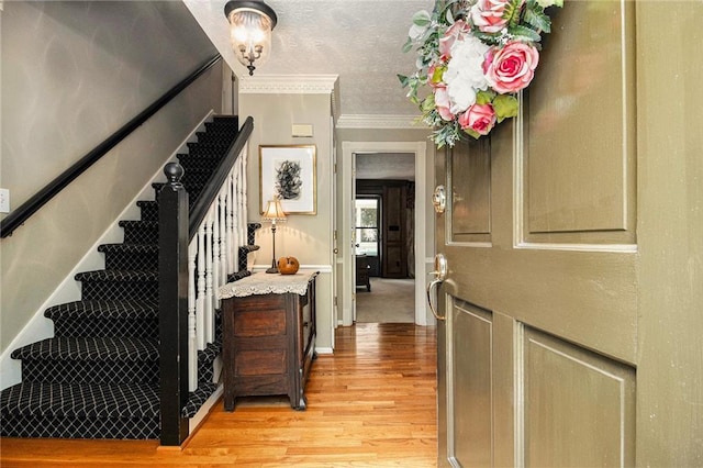 5396 Amhurst Dr, Peachtree Corners, GA 30092 - entryway with light wood-type flooring, stairs, crown molding, and a textured ceiling