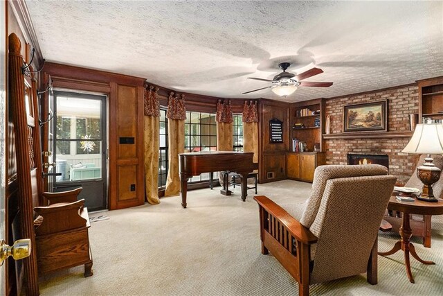 5396 Amhurst Dr, Peachtree Corners, GA 30092 - living area featuring light colored carpet, healthy amount of natural light, ceiling fan, a brick fireplace, and a textured ceiling