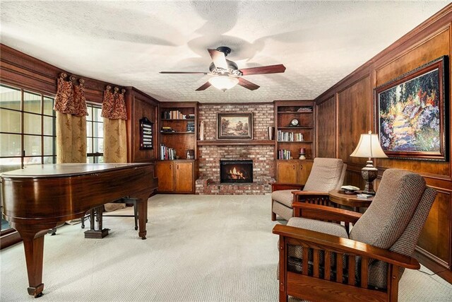 5396 Amhurst Dr, Peachtree Corners, GA 30092 - sitting room with ceiling fan, a brick fireplace, light colored carpet, wood walls, and a textured ceiling