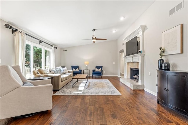 living room featuring ceiling fan, dark hardwood / wood-style floors, and a high end fireplace