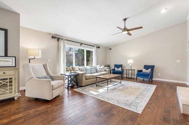 living room featuring vaulted ceiling, dark hardwood / wood-style floors, and ceiling fan