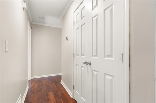 hall featuring dark wood-type flooring and ornamental molding